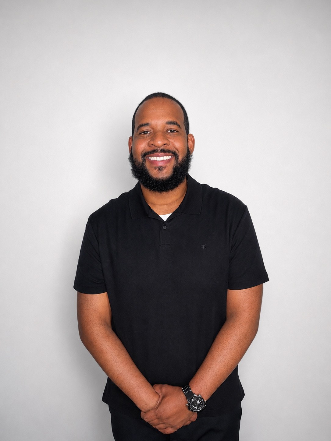 Matthew Robinson smiling in a black polo shirt